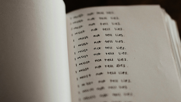 Someone writing I must not lie over and over Someone writing I must not lie over and over