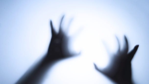 Hands against glass, abstract, fearful Hands against glass, abstract, fearful